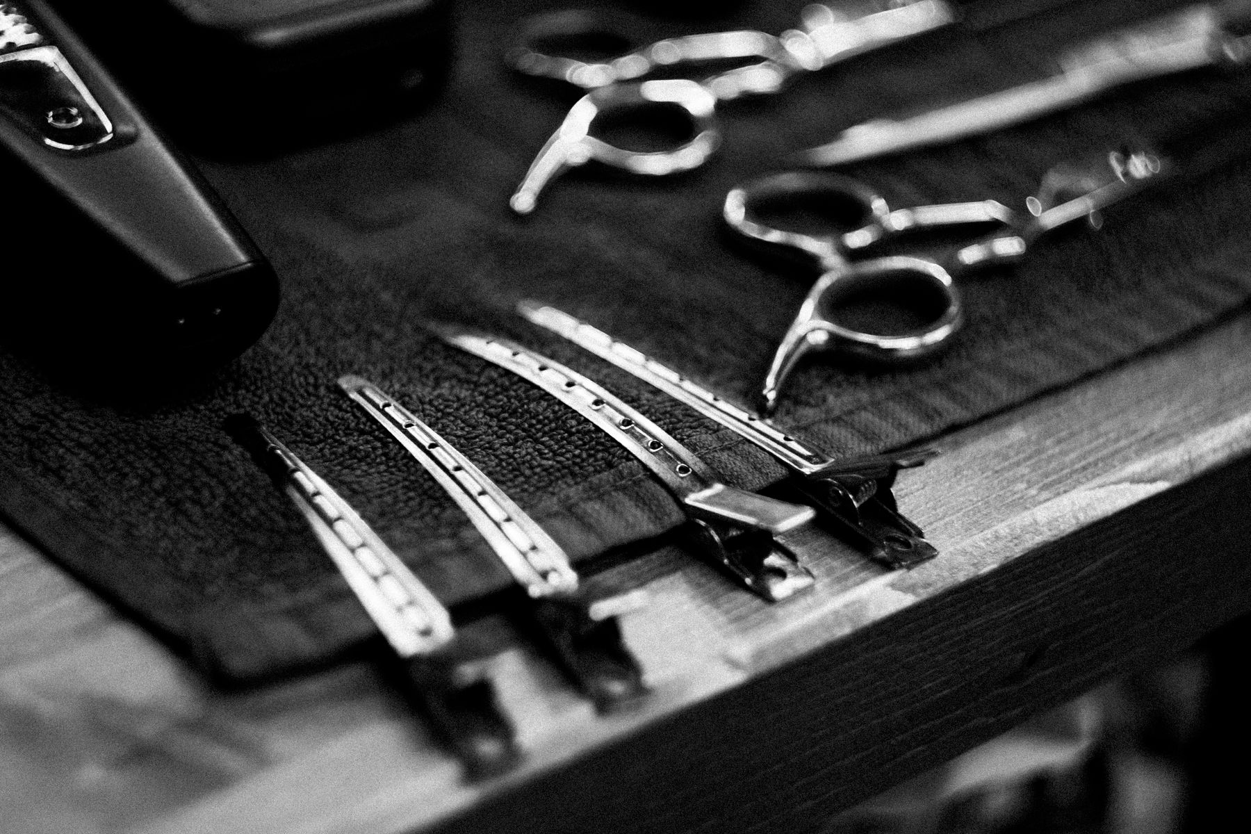 Barber scissors, combs and clips on a towel, illustrative stock